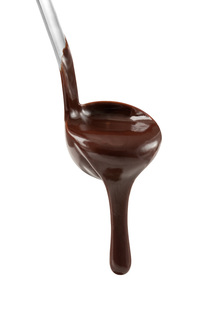 Melted chocolate dripping from a ladle